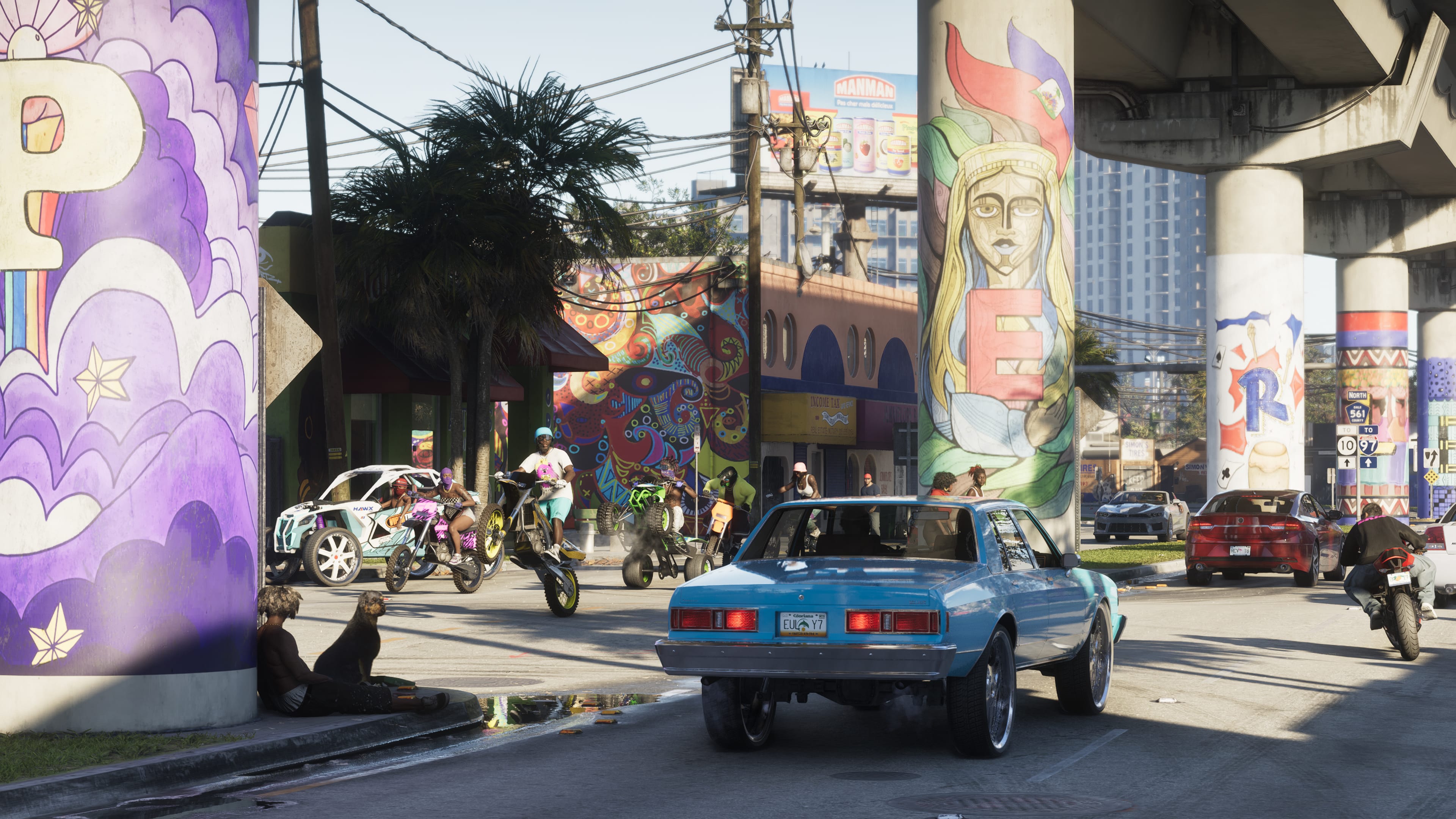 Motorcycles, cars and pedestrians share a Vice City street beneath brightly painted elevated-road pillars