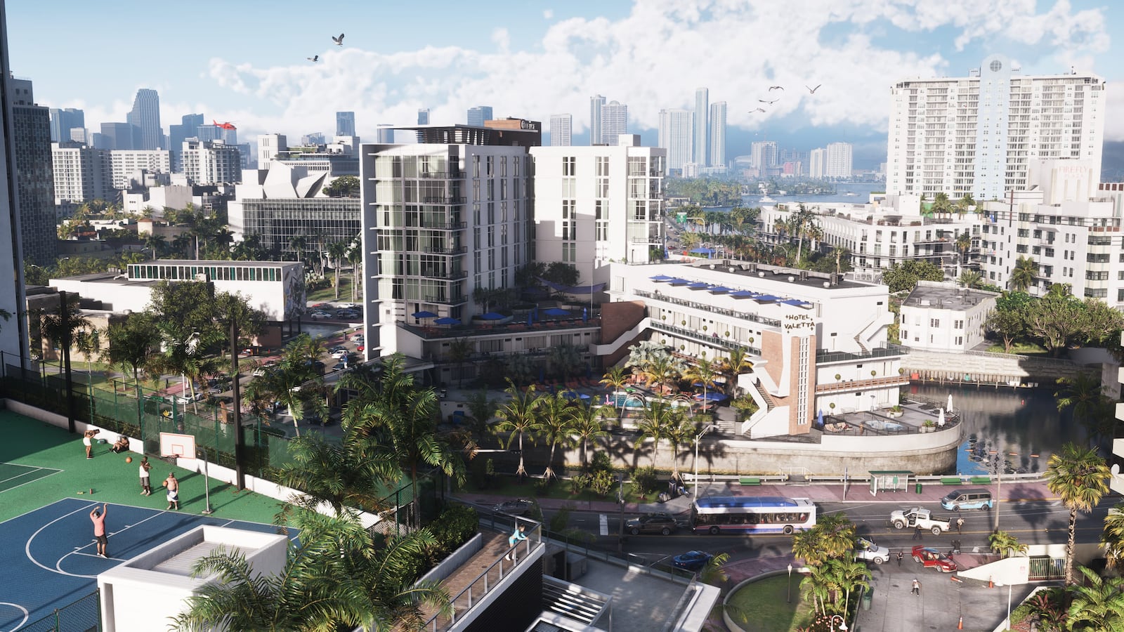 Daylight view of Vice City hotels, basketball courts, palm trees and traffic in an official GTA VI screenshot.