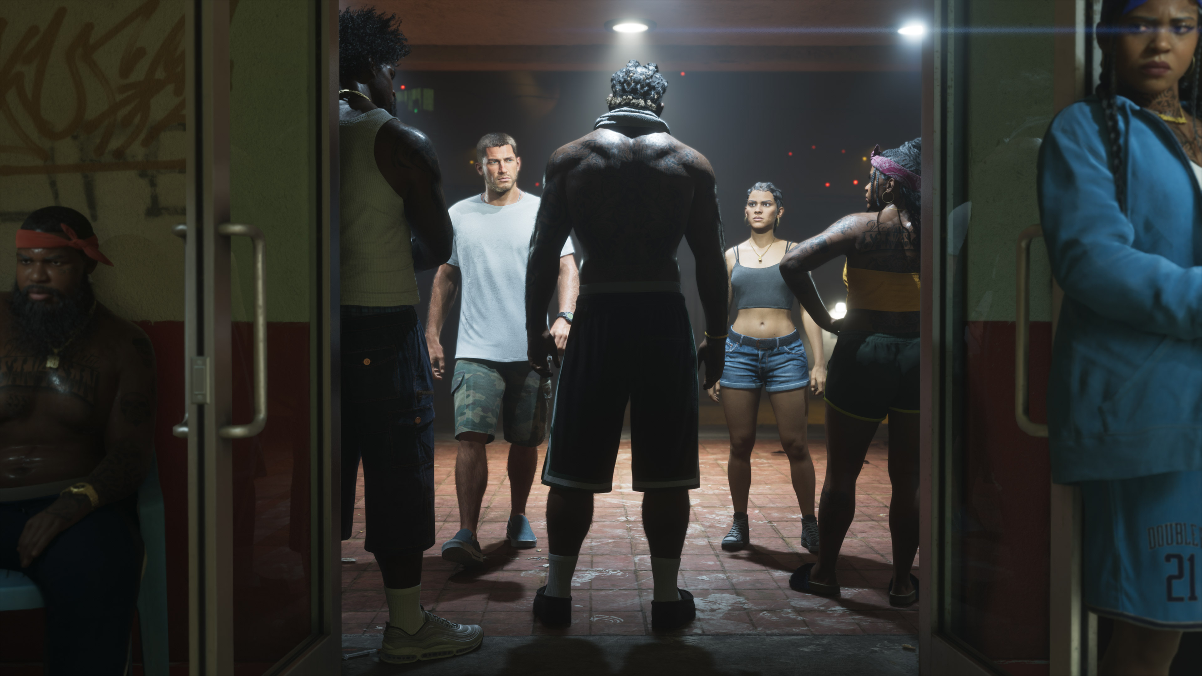Jason and Lucia facing a group inside a building in an official GTA VI screenshot